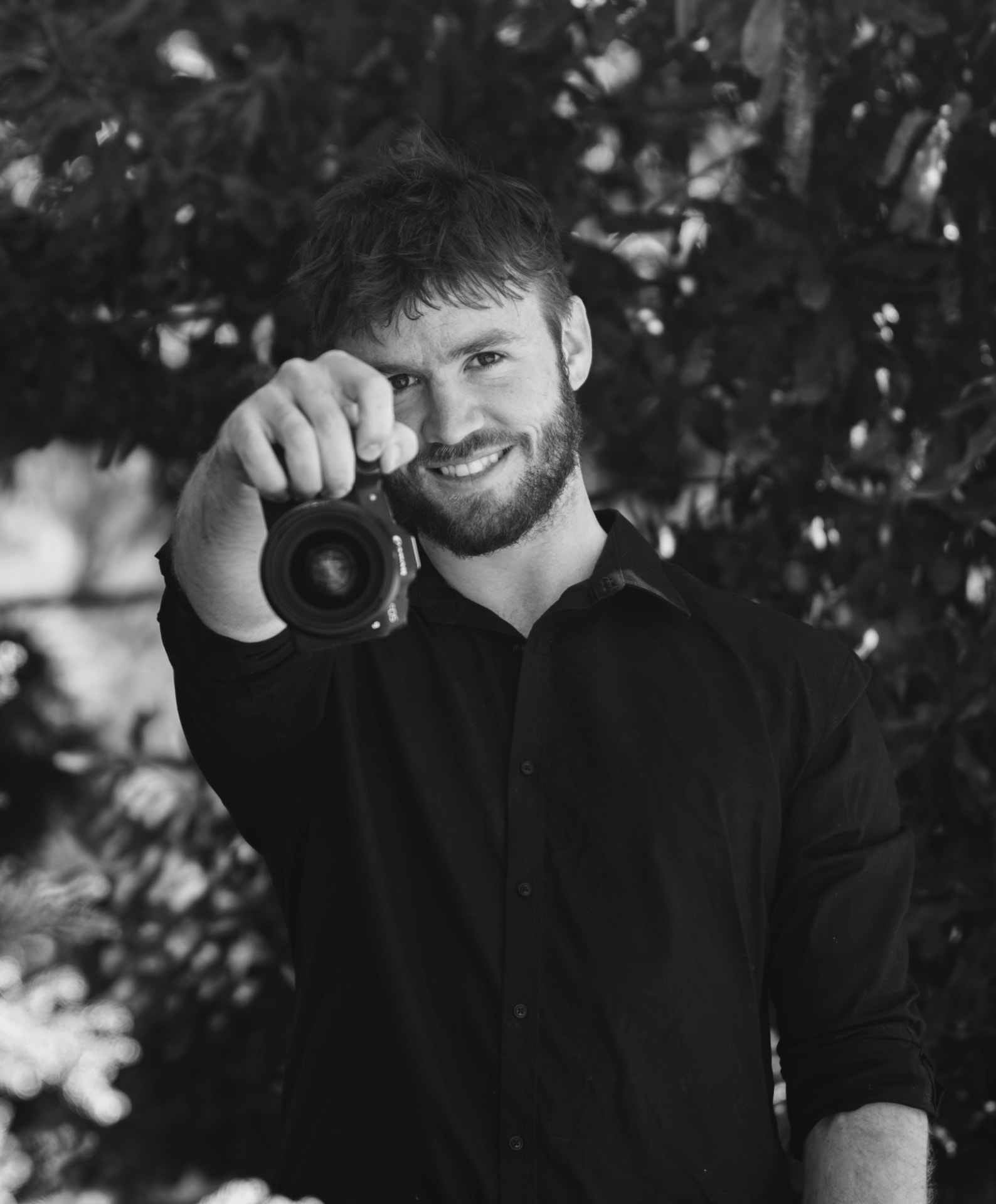 Tiernan, DunnMedia photographer, holding a camera